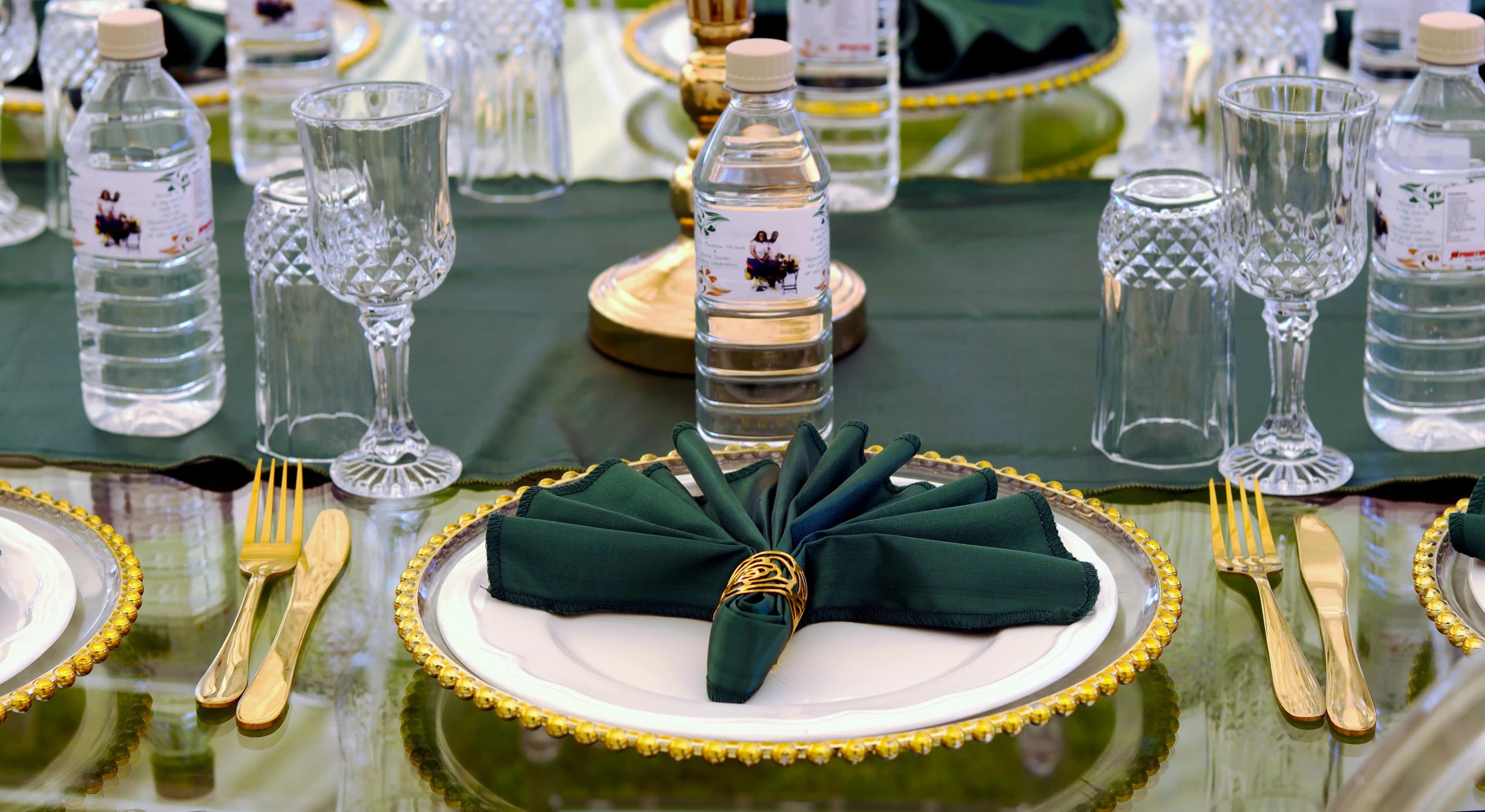 A refined dining table set with glassware and gold cutlery.