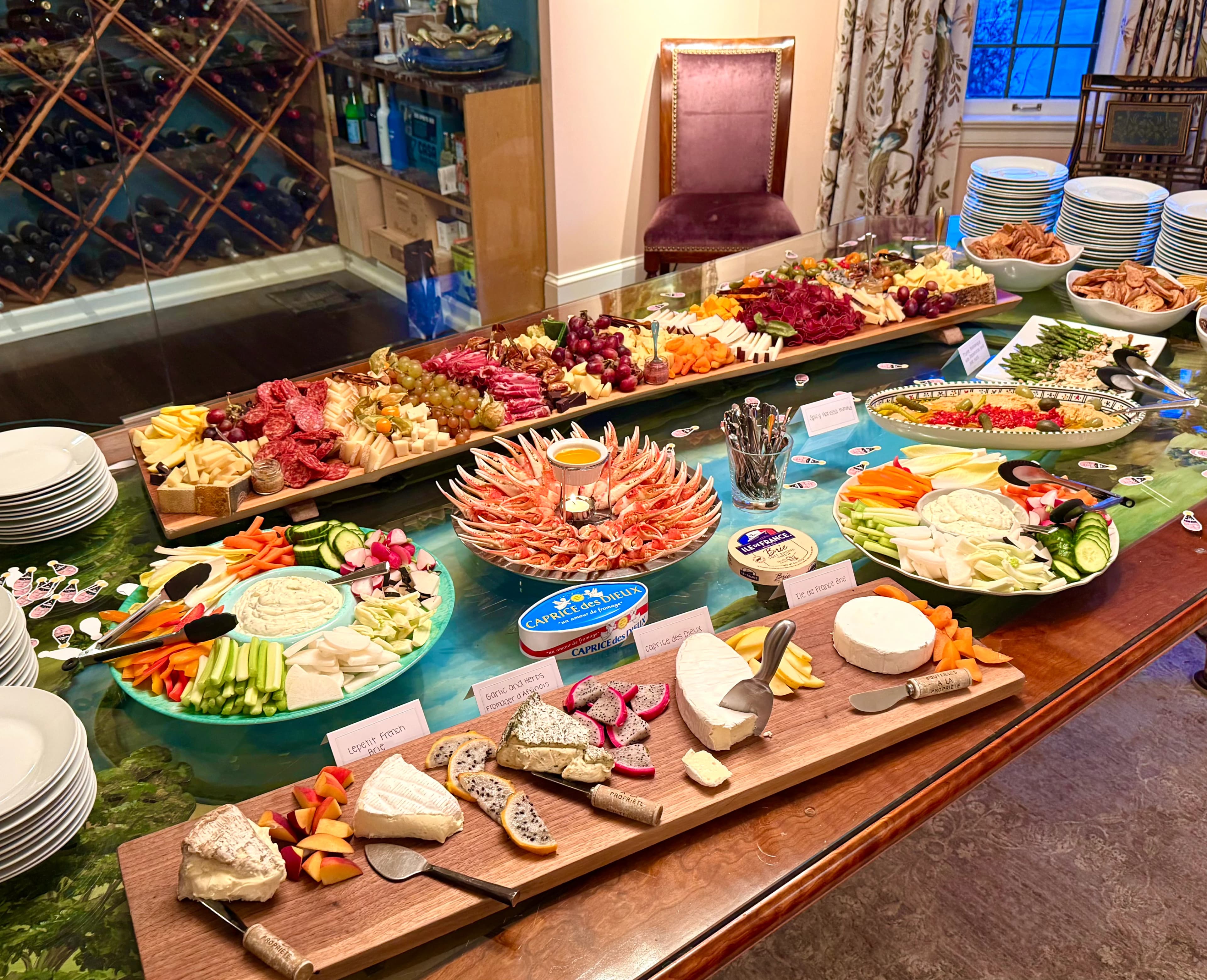 A grand private dining spread with charcuterie, seafood, cheeses, fruit, and vegetables.